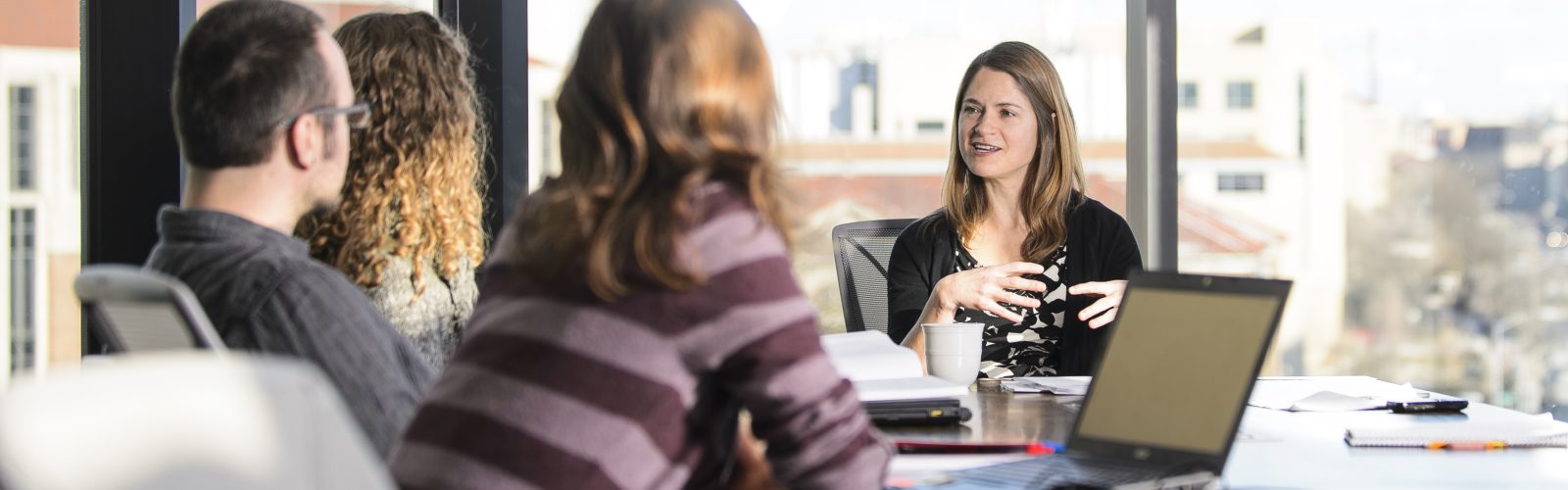 Holly Gibbs, assistant professor in the Department of Geography, meets with her graduate research students in the Wisconsin Energy Institute at the University of Wisconsin-Madison on Feb. 10, 2016. Gibbs is one of twelve 2016 Distinguished Teaching Award recipients. (Photo by Bryce Richter / UW-Madison)